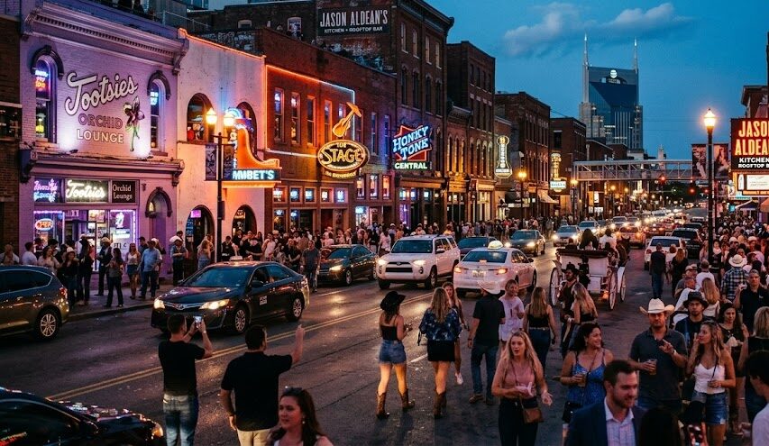 Neon signs and lively crowds on Broadway in Nashville, Tennessee.