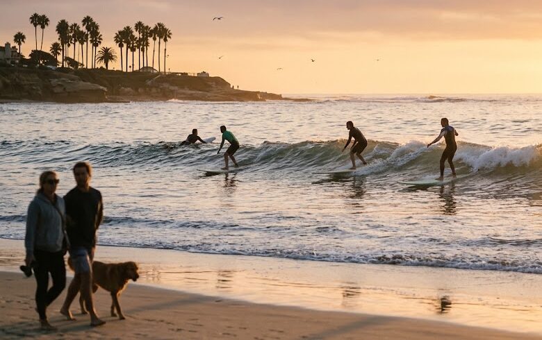 Surfers enjoying the sunny coastal beach weather in San Diego.