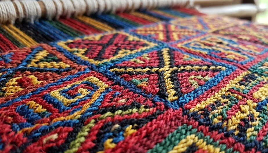 Art of Inca: Close up of an ancient Inca textile showing intricate geometric patterns.