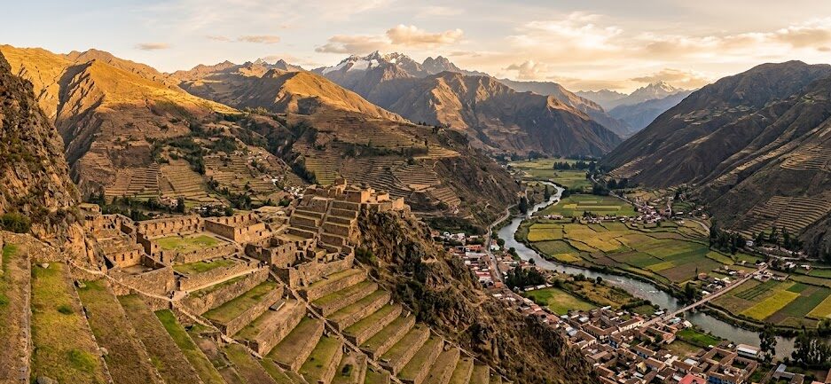 Panoramic view of the Sacred Valley of the Incas featuring agricultural terraces and ancient ruins.