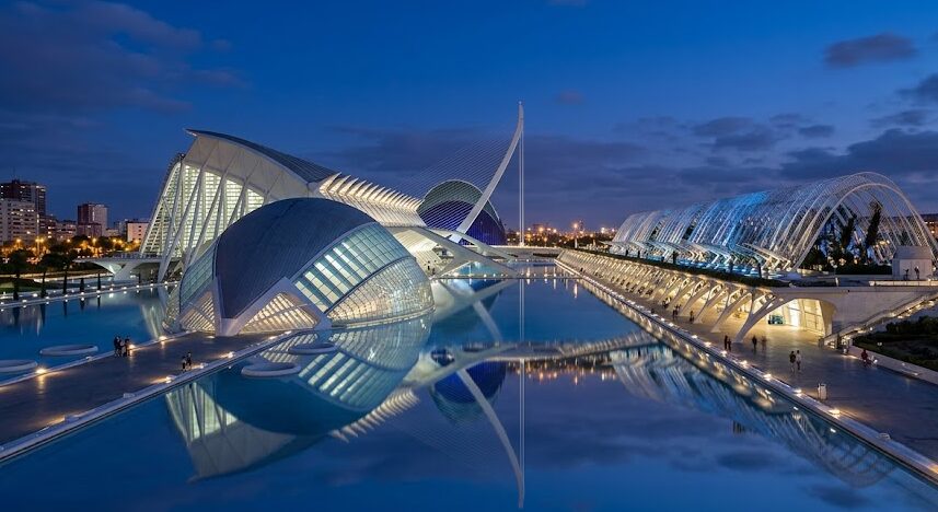 The futuristic architecture of the City of Arts and Sciences reflecting on water in Valencia, Spain.